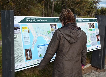 Looking at one of the many newborough forest signs