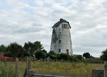 Melin Cemaes from the road with field