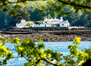 The beautiful Ynys Gorad Goch on the menai strait through the trees