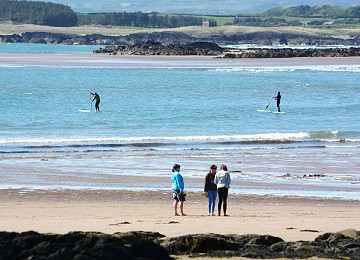 Two paddleboarders at Rhosneigr