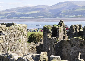 Beaumaris castle overlooks the Menai Strait and mountains of Snowdonia in North Wales