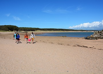 People access Llanddwyn Island at low tide