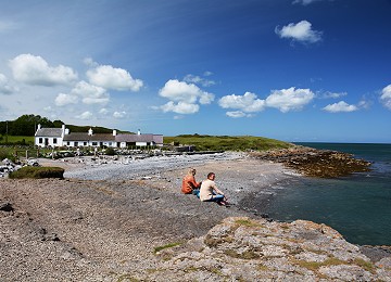 Visitors enjoy the view at Moelfre North beach